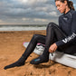 Surfski paddler wearing neoprene socks on a beach